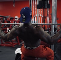 a man doing a squat in a gym